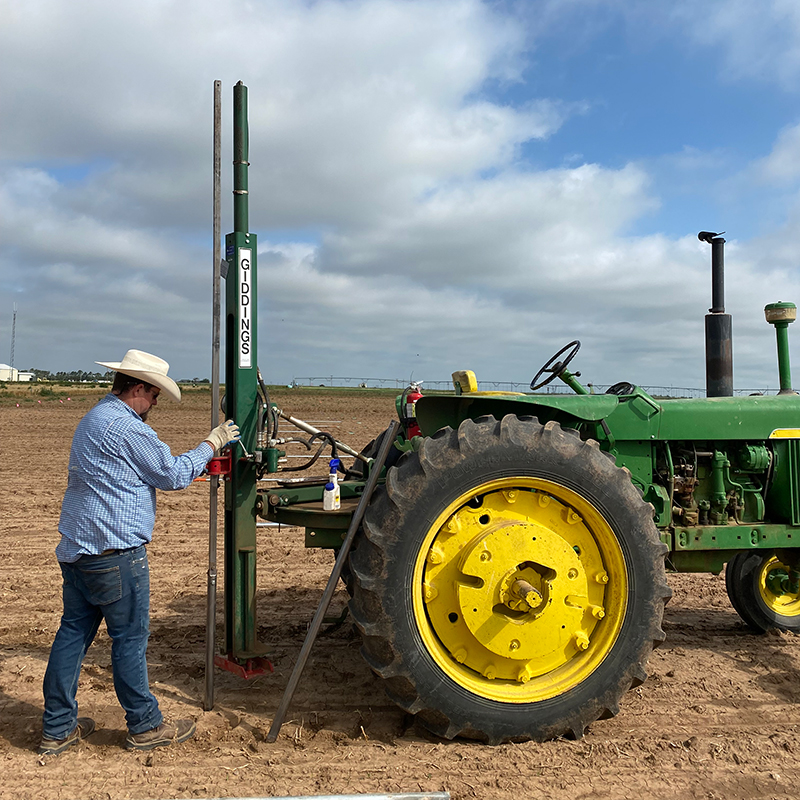 Man working behind John Deere tractor